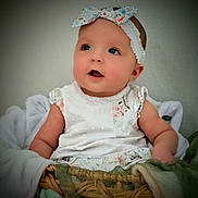 Winslie joined the competition — help win amazing prizes! baby, infant, child, headband, bow, dress, floral, basket, blanket, soft_texture, rosy_cheeks, portrait, smile, eyes, eyelashes, sitting, indoors, vignette, cute, fabric