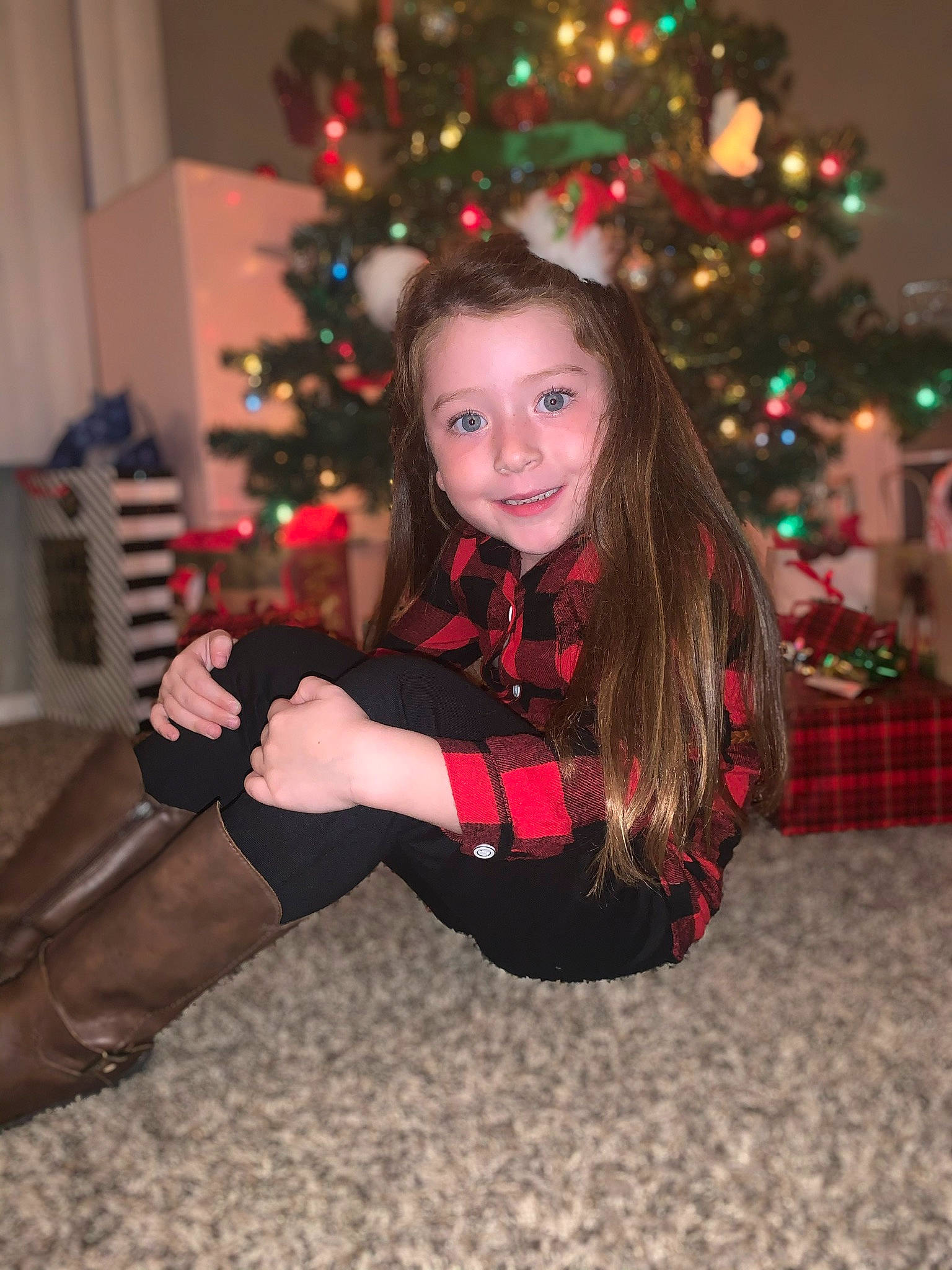 Kendall is registered to the contest to win money with this photo: christmas, christmas_decoration, christmas_ornament, christmas_tree, event, fun, happy, holiday, human_body, joy, lighting, ornament, pattern, person, plant, smile, sock, standing, thigh, toddler
