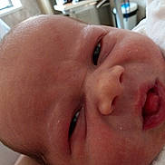 Arwin is registered to the contest to win money with this photo: baby, newborn, face, closeup, infant, skin, mouth, eyes, expression, head, person, indoors, sleepwear, soft, cute, child, human, portrait, newborn_baby, cozy
