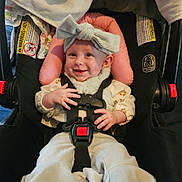 Lyla joined the competition — help win amazing prizes! baby, car_seat, headband, smile, child, infant, seatbelt, clothing, sitting, hands, face, cute, indoor, safety, child_safety, portrait, happy, wearing, young_child, accessory
