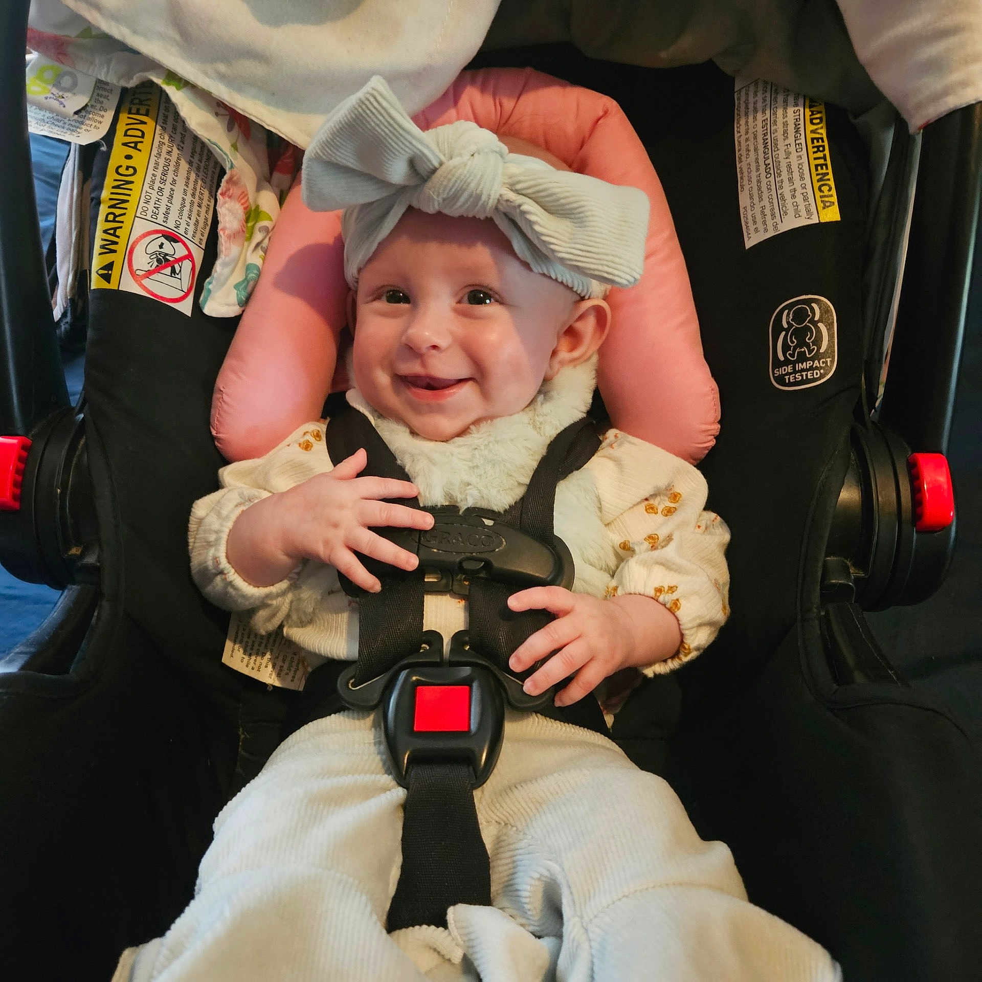 Lyla joined the competition — help win amazing prizes! baby, car_seat, headband, smile, child, infant, seatbelt, clothing, sitting, hands, face, cute, indoor, safety, child_safety, portrait, happy, wearing, young_child, accessory