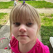 Grace is registered to the contest to win money with this photo: child, girl, blonde_hair, hair_clip, pink_shirt, close_up, face, outdoor, grass, sidewalk, chalk_drawing, bicycle, boy, pickup_truck, car, suburban, residential_area, daylight, casual_clothing, portrait