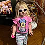 Grace joined the competition — help win amazing prizes! child, girl, indoor, blonde, sunglasses, pink_shirt, minnie_mouse, toy, barefoot, wooden_floor, sweatpants, home, television, furniture, playful, smiling, person, casual_clothing, living_room, swing