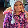 child, girl, hat, knit_hat, cat_ears, jacket, pink, purple, leopard_print, smile, indoor, blonde_hair, face, person, warm_clothing, cute, portrait, young_child, happy, winter_clothes