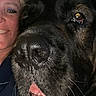 animal, black_dog, brown markings, close_up, companion, dog, eyes, face, fur, indoors, large_dog, nose, open_mouth, person, pet, portrait, selfie, smiling, tongue, woman