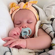 Amelia joined the competition — help win amazing prizes! baby, sleeping, pacifier, headband, blanket, infant, closeup, cute, child, soft, cozy, resting, peaceful, indoors, portrait, hand, face, newborn, comfort, toddler