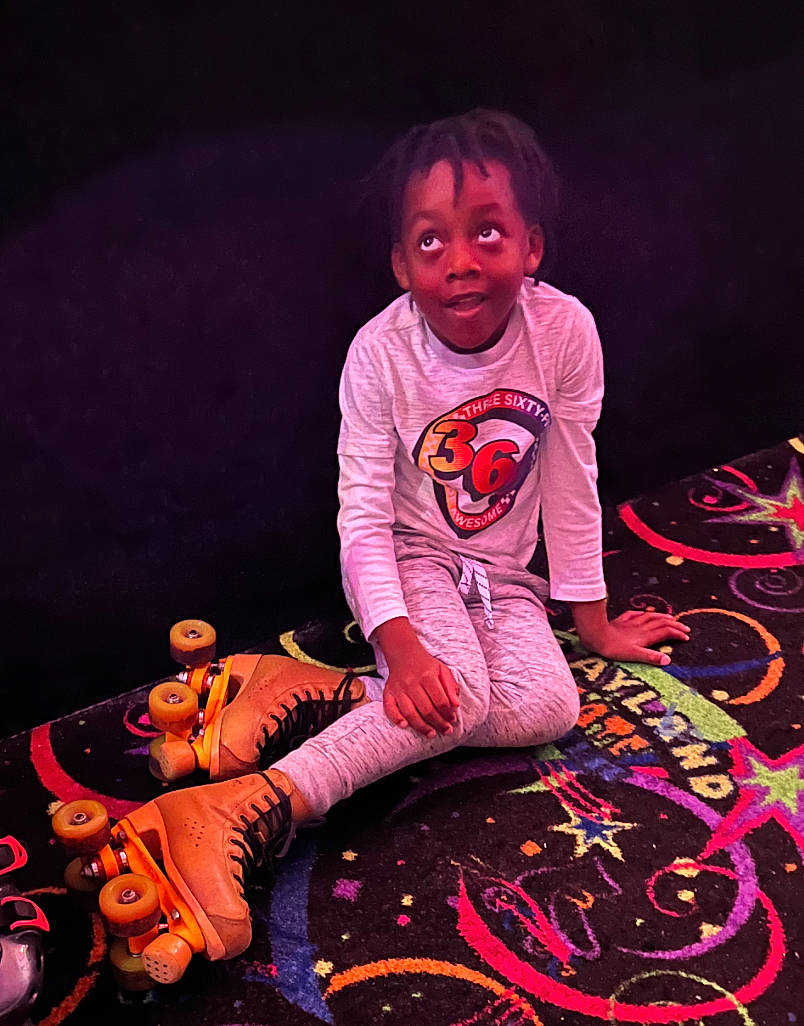 Hasani joined the competition — help win amazing prizes! art, artist, carmine, darkness, entertainment, event, flash_photography, fun, happy, magenta, music, performance, performing_arts, person, pink, purple, sitting, sleeve, t_shirt, toddler