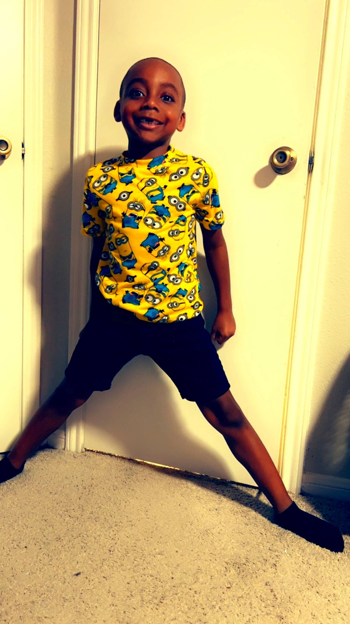 Hasani is registered to the contest to win money with this photo: arm, door, elbow, electric_blue, face, fashion_design, flash_photography, flooring, hand, happy, human_body, joy, knee, leg, neck, person, sleeve, sportswear, t_shirt, thigh