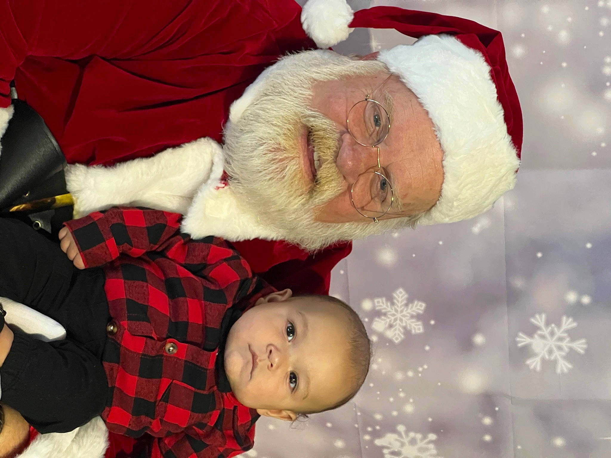 Zyaire is registered to the contest to win money with this photo: baby, carmine, child, christmas, christmas_eve, christmas_ornament, event, fictional_character, fur, happy, headwear, holiday, lap, pattern, person, plaid, red, santa_claus, smile, tartan