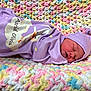 Astrid joined the competition — help win amazing prizes! newborn, baby, sleeping, blanket, knitted, pastel_colors, purple, hat, cute, infant, soft, cozy, resting, child, portrait, wrapped, illustration, pattern, warm, peaceful