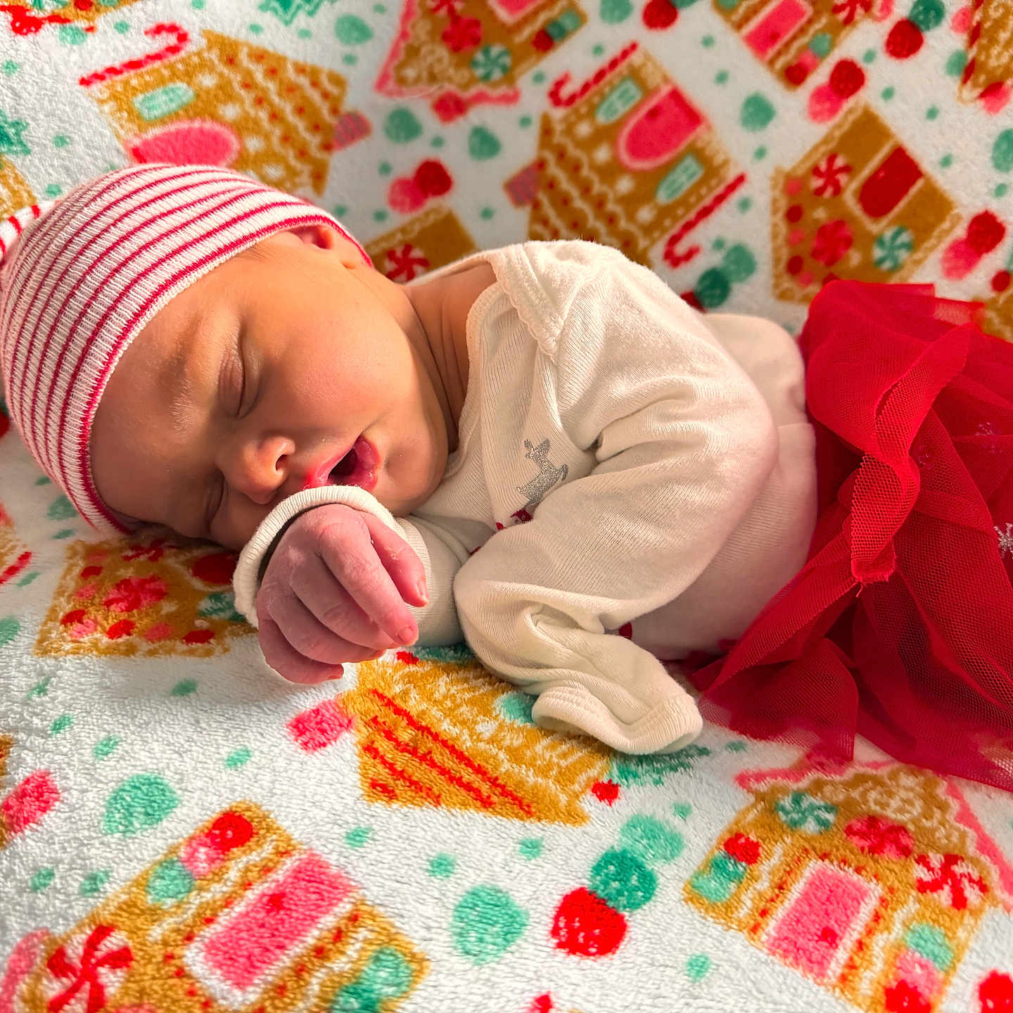 Astrid is registered to the contest to win money with this photo: baby, blanket, child, christmas, cozy, cute, festive, gingerbread_house, hat, holiday, infant, newborn, pattern, portrait, red, resting, sleeping, soft, tulle_skirt, white