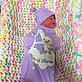 newborn, baby, sleeping, swaddle, blanket, crochet, pastel_colors, purple_clothing, hat, infant, cute, cozy, resting, face, child, soft_texture, pattern, comfort, indoors, peaceful