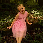 Alaya joined the competition — help win amazing prizes! child, girl, pink_dress, forest, nature, smile, sitting, tree, log, greenery, leaves, outdoor, sunlight, happy, portrait, summer, sandals, woods, cute, young