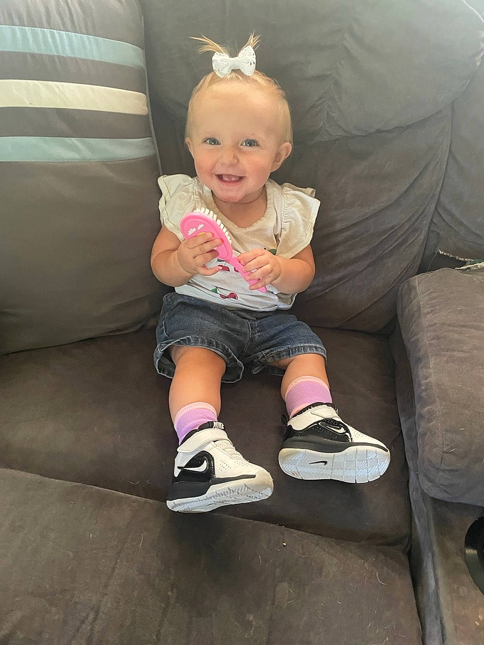 Everlynn is registered to the contest to win money with this photo: arm, baby_toddler_clothing, comfort, couch, dress, eye, face, facial_expression, finger, hair, head, human_body, iris, joy, knee, leg, person, pink, skin, sleeve