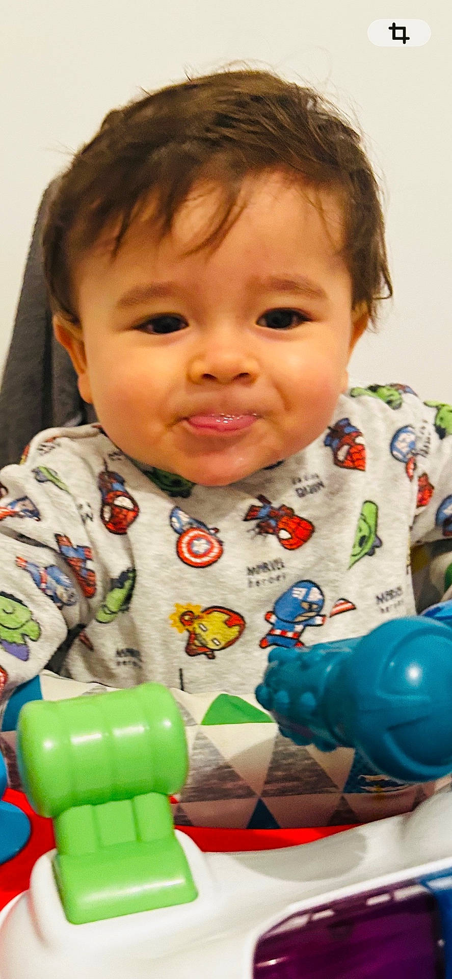 activity_center, baby, child, colorful, cute, entertainment, expression, face, fun, hair, indoor, person, plastic, playtime, shirt, smiling, superhero, toddler, toy, young_child