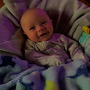 Alijha joined the competition — help win amazing prizes! baby, blanket, smiling, infant, cozy, soft, sleepwear, cute, happy, face, indoors, child, warm, furniture, wood, cabinet, portrait, person, comfort, rest