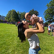 Wrenlee joined the competition — help win amazing prizes! woman, baby, child, outdoor, park, grass, trees, sky, sunny, happy, lifting, casual, people, nature, summer, greenery, smile, daylight, family, fun