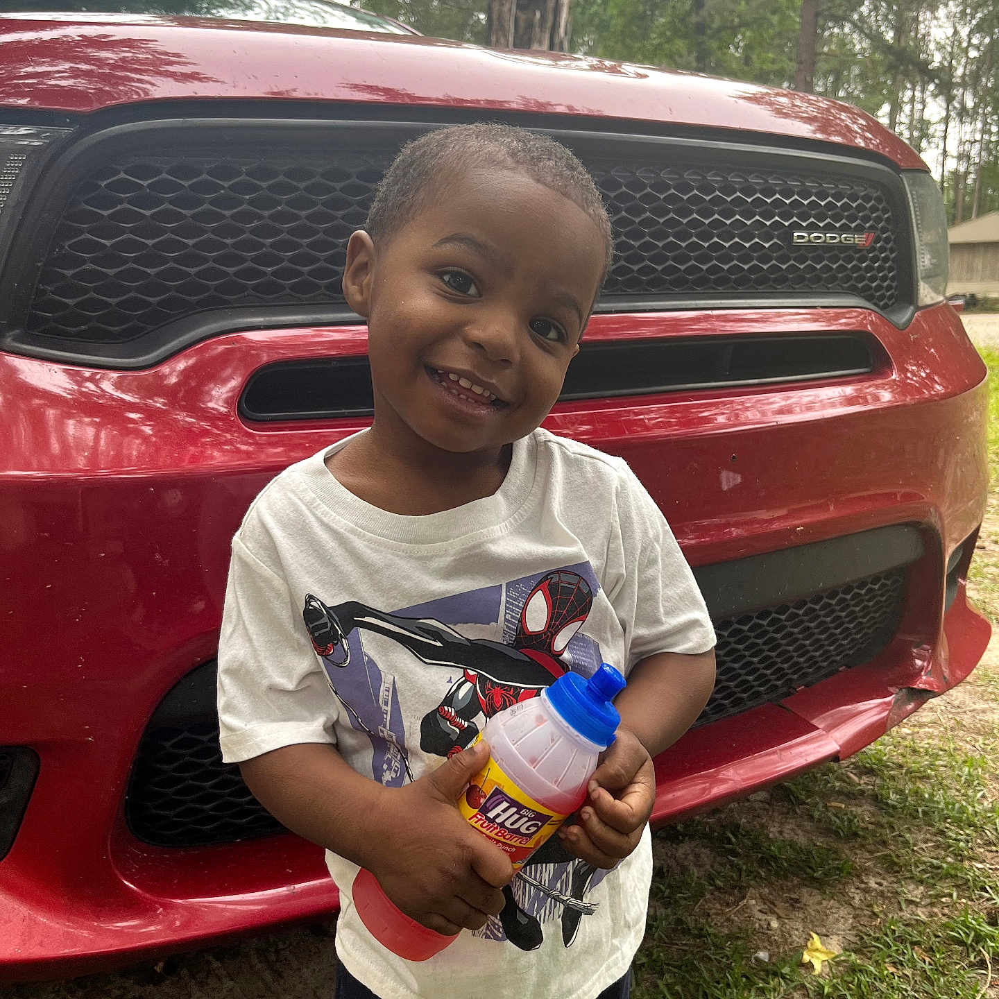 Seyven joined the competition — help win amazing prizes! child, boy, smiling, red_car, dodge, outdoor, grass, trees, tshirt, spiderman, drink_bottle, fruit_punch, happy, portrait, daylight, casual_clothing, person, vehicle, nature, cute