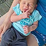 Nash joined the competition — help win amazing prizes! baby, infant, sleeping, person, tattoo, blue_clothing, gray_pants, hand, foot, outdoor, gravel, wooden_planks, skin, arm, lap, closeup, cute, peaceful, casual, relaxing
