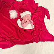 Percy is registered to the contest to win money with this photo: newborn, baby, sleeping, red_blanket, santa_hat, white_wrap, infant, cute, holiday_theme, soft_texture, portrait, cozy, small_hands, peaceful, wrapped, christmas, festive, sleep, child, indoors