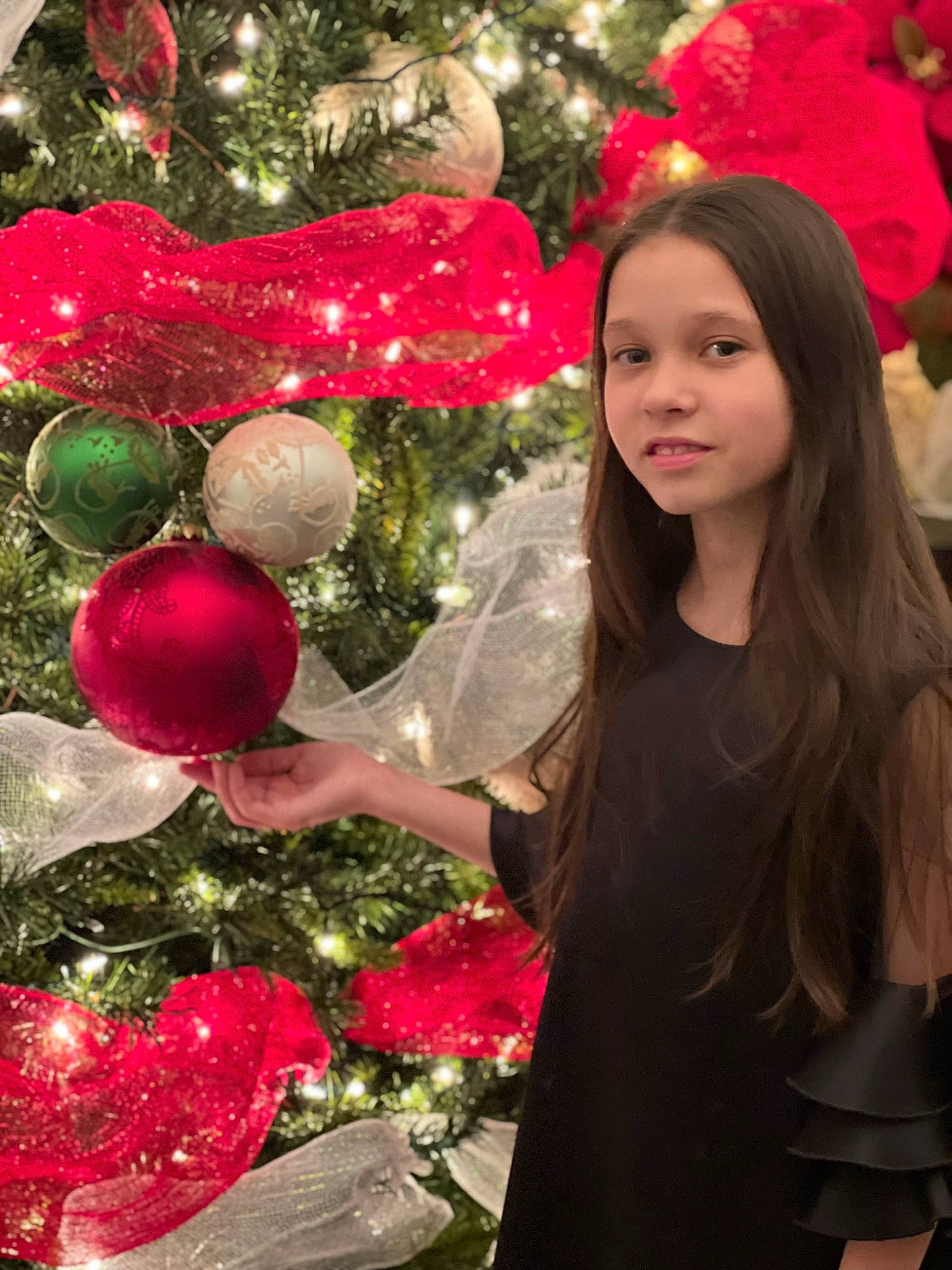 Veronika is registered to the contest to win money with this photo: christmas, christmas_decoration, christmas_eve, christmas_ornament, christmas_tree, conifer, event, evergreen, facial_expression, happy, holiday, holiday_ornament, joy, ornament, person, plant, red, sleeve, toy, tradition