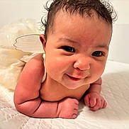 Daniella joined the competition — help win amazing prizes! baby, infant, smiling, face, curly_hair, fairy_wings, cute, lying_down, skin, tummy, cheeks, expression, indoor, soft_lighting, white_background, person, newborn, adorable, cute_pose, happy