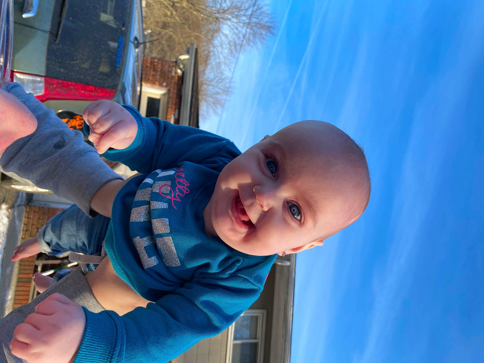 Mercedes is registered to the contest to win money with this photo: arm, azure, baby, baby_toddler_clothing, blue, elbow, electric_blue, finger, gesture, hand, happy, leisure, person, recreation, sky, smile, toddler, travel, tree, water