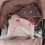 baby, sleeping, blanket, hood, star_pattern, stroller, cushion, soft, cozy, child, infant, face, resting, covered, warm, fabric, closeup, comfort, peaceful, wrapped