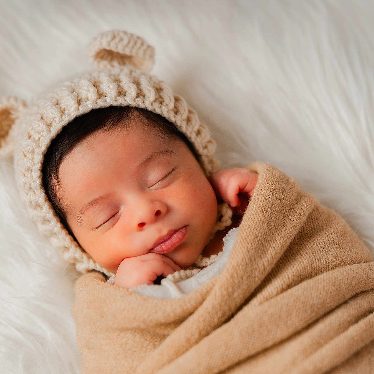 Adam joined the competition — help win amazing prizes! baby, bear_ears, beige, blanket, closed_eyes, cozy, cute, faux_fur, hand_near_face, headshot, infant, knit_hat, newborn, peaceful, portrait, sleeping, soft_texture, studio_photography, swaddle, white_background