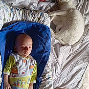 Eden a rejoint le concours — aidez-le/la à gagner de superbes lots ! baby, sleeping, cat, white_cat, bed, blanket, pajamas, blue_cushion, indoor, resting, peaceful, cute, animal, child, nap, soft_light, home, furniture, comfort, relaxation