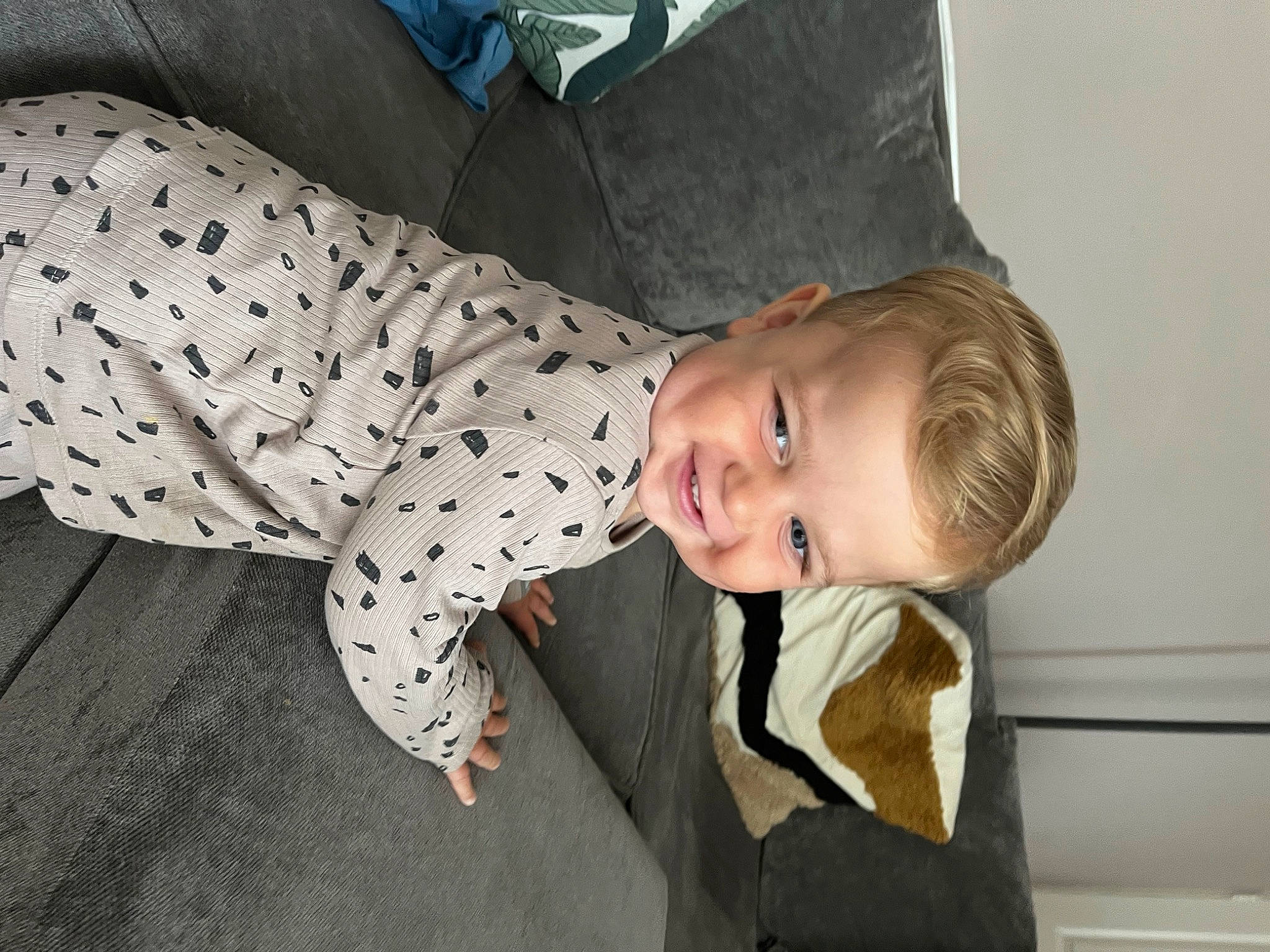 Billy is registered to the contest to win money with this photo: baby, baby_toddler_clothing, child, comfort, flooring, fun, happy, joy, laugh, pattern, person, sitting, sleeve, smile, suit, toddler, tree, wood
