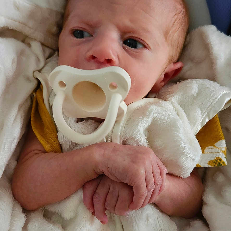 Stephanie is registered to the contest to win money with this photo: baby, bed, blanket, bodypart, clothing, couch, cushion, face, finger, furniture, hand, hat, head, homedecor, newborn, person, photography, portrait, quilt, sleeping