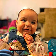 Amelia joined the competition — help win amazing prizes! baby, child, smiling, cute, denim, monkey_patch, toy, food, messy, face, portrait, indoor, playful, happy, young_child, clothing, colorful, hands, expression, infant