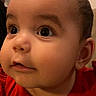 Amelia is registered to the contest to win money with this photo: baby, face, child, infant, cute, red_shirt, indoor, closeup, curious, chubby_cheeks, person, portrait, young, looking_away, skin, head, expression, eyelashes, ear, soft_lighting