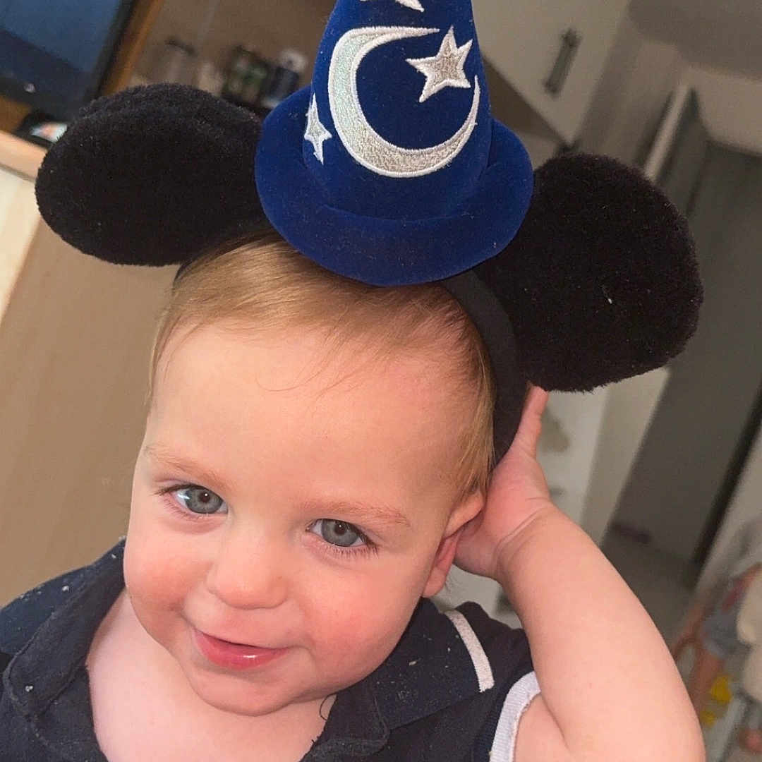 Lyzio joined the competition — help win amazing prizes! toddler, child, boy, hat, wizard_hat, mickey_mouse_ears, smile, blue_eyes, indoor, kitchen, cabinet, shirt, black_shirt, short_sleeves, light_skin, cute, playful, portrait, young_child, headwear