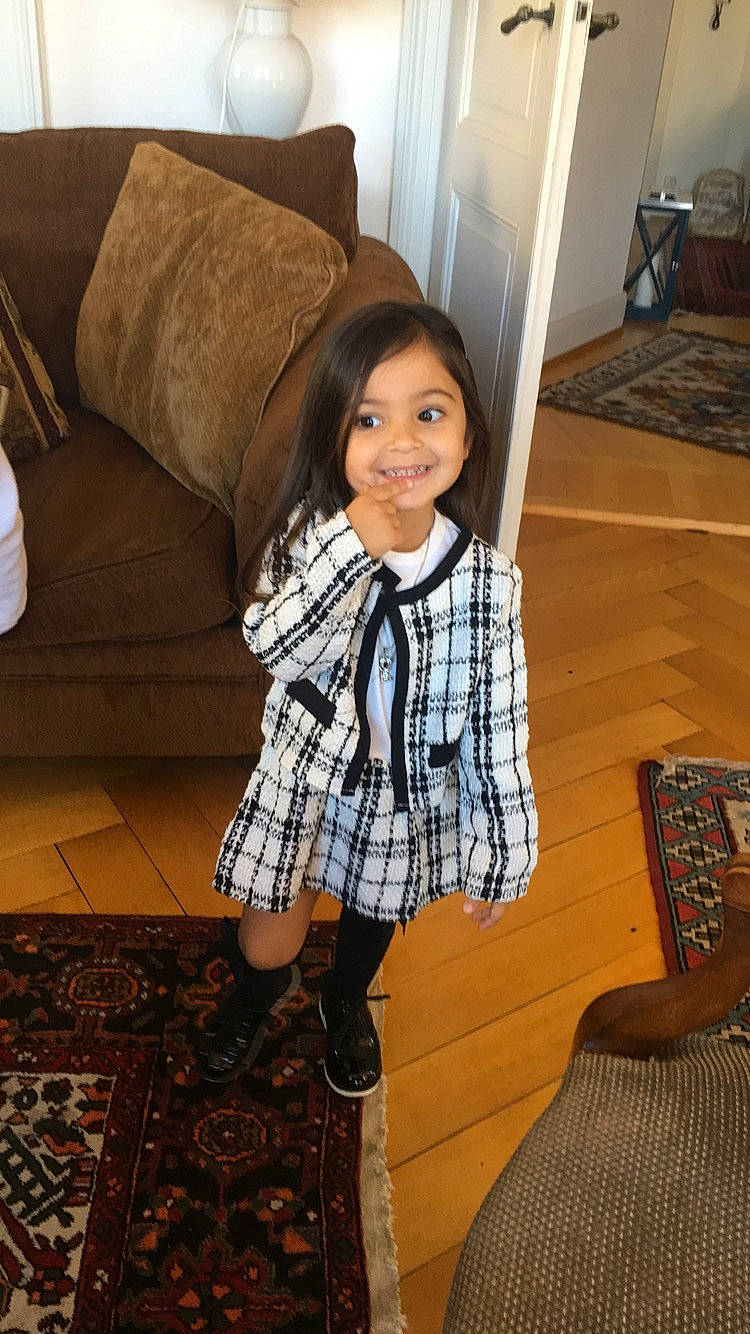 Isalys a rejoint le concours — aidez-le/la à gagner de superbes lots ! black_hair, comfort, face, floor, flooring, hairstyle, happy, hardwood, human, interior_design, joy, knee, leg, people, person, plaid, smile, standing, tartan, textile