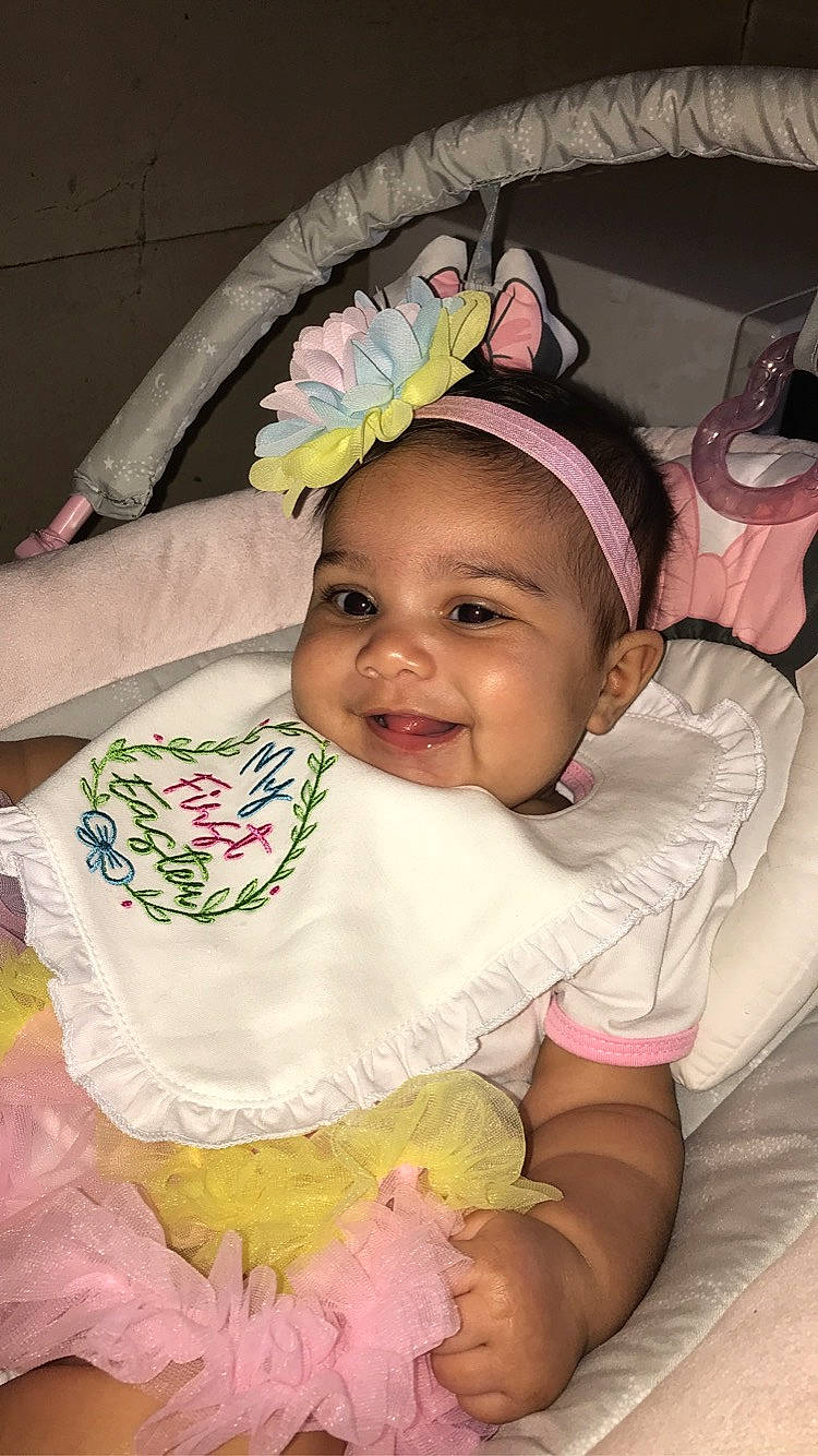 Serenity is registered to the contest to win money with this photo: baby, baby_products, baby_toddler_clothing, cheek, child, comfort, eye, eyelash, fashion_accessory, fun, happy, headband, headwear, iris, joy, linens, pattern, person, pink, skin