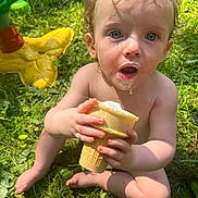 Nevada joined the competition — help win amazing prizes! barefoot, child, cone, curly_hair, cute, daytime, food, grass, happy, ice_cream, messy, nature, outdoor, play, sitting, skin, summer, sunlight, toddler, toy
