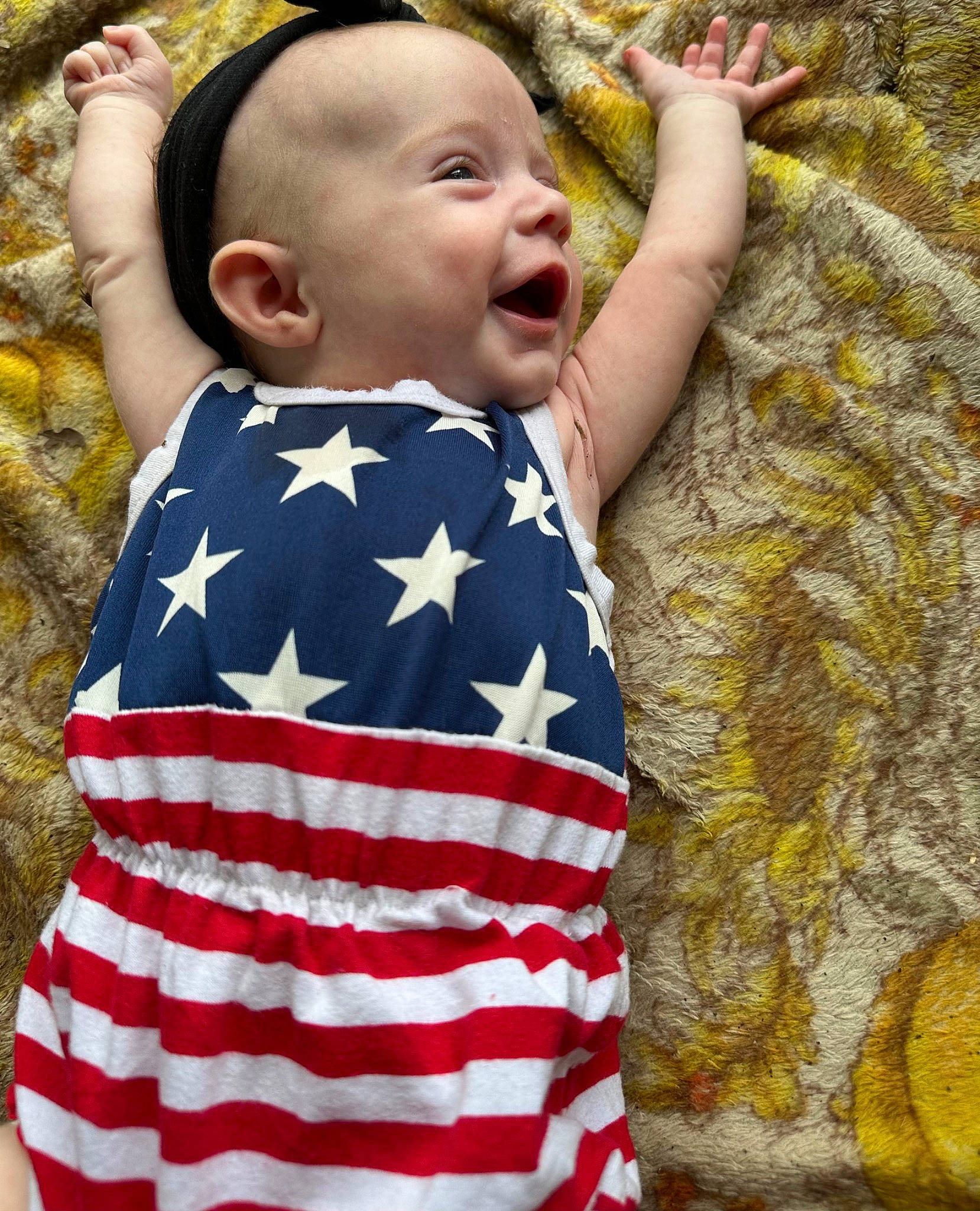 Patience is registered to the contest to win money with this photo: baby, baby_toddler_clothing, child, dress, eye, face, flag_day_usa, flag_of_the_united_states, fun, grass, happy, head, leaf, leisure, pattern, people_in_nature, person, sitting, skin, toddler