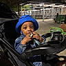 Dwane Jr. joined the competition — help win amazing prizes! toddler, child, baby, stroller, blue_hat, denim_jacket, night, outdoor, park, bench, metal_structure, curious, chewing, footwear_off, person, seat, dark, lighting, urban, casual_clothing