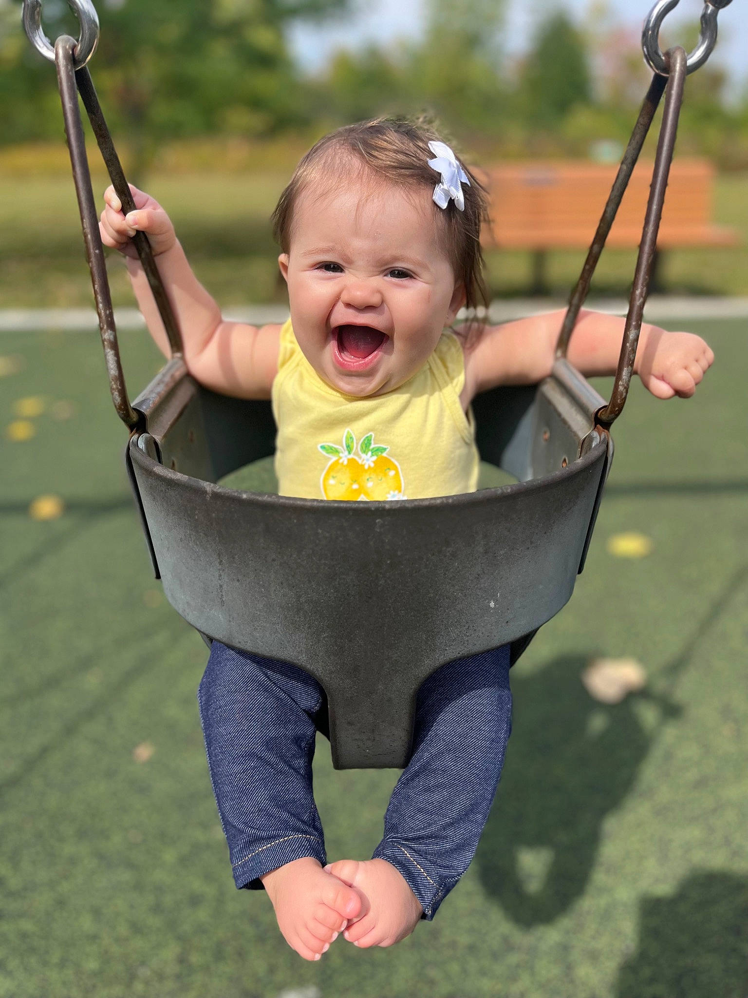 Brinley joined the competition — help win amazing prizes! baby, baby_toddler_clothing, child, city, finger, fun, grass, hand, happy, human_settlement, leisure, people_in_nature, person, public_space, recreation, skin, sleeve, smile, swing, toddler