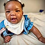 Za'Karriyah is registered to the contest to win money with this photo: baby, infant, smiling, crawling, blue_clothing, white_bib, bed, happy, cute, portrait, child, young_child, indoors, person, face, skin, hair, hand, expression, closeup