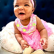 Za'Karriyah joined the competition — help win amazing prizes! baby, girl, smiling, pink, headband, dress, pillow, cushion, happy, infant, child, cute, portrait, indoors, soft, clothing, skin, person, sitting, toddler