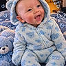 baby, child, infant, smiling, portrait, blue, onesie, hood, bear, teddy_bear, blanket, plush, sitting, indoors, cozy, happy, cute, face, text_overlay, hearts