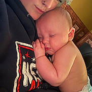 Malachi joined the competition — help win amazing prizes! adult, affection, baby, caregiver, chair, child, close_up, cozy, cuddling, diaper, face, family, indoor, infant, nap, portrait, shirt, sleeping, sleepy, warm_lighting