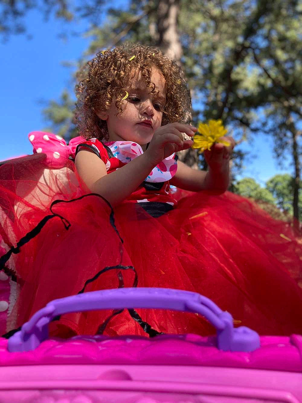 Malia joined the competition — help win amazing prizes! child, entertainment, event, festival, fun, grass, happy, leisure, magenta, people_in_nature, performing_arts, person, pink, public_event, recreation, sitting, sky, smile, toddler, tree