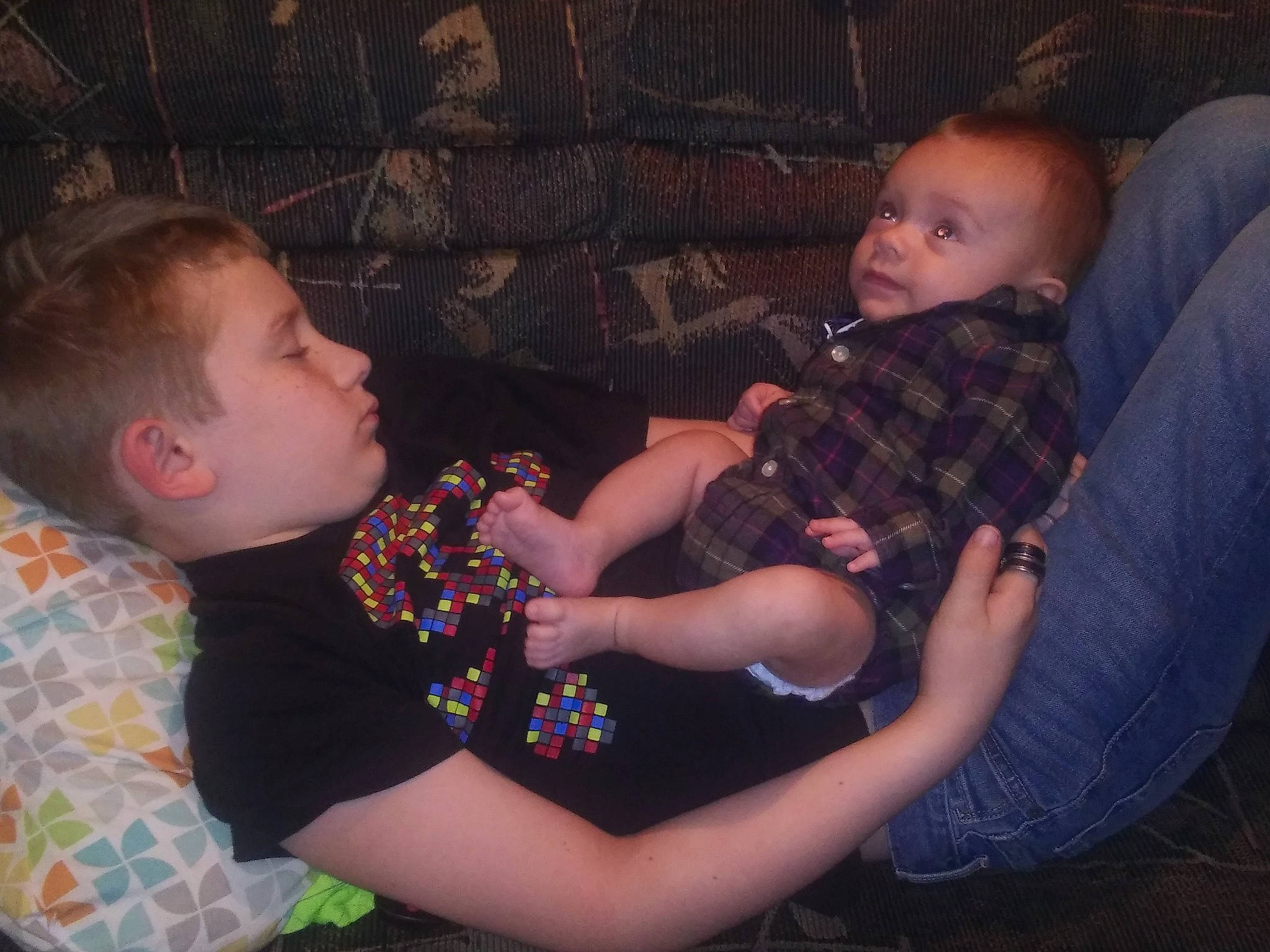 Bradley is registered to the contest to win money with this photo: arm, cheek, child, cool, design, eye, fun, head, human, human_body, interaction, iris, leg, organ, people, person, plaid, sitting, skin, snapshot