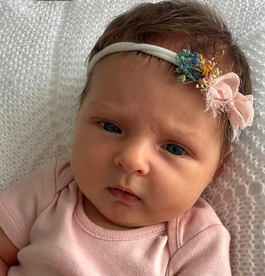 Summer joined the competition — help win amazing prizes! baby, infant, face, headband, pink_clothing, blanket, portrait, closeup, cute, child, newborn, soft_lighting, expression, resting, indoors, person, young_child, skin, hair, sleepwear