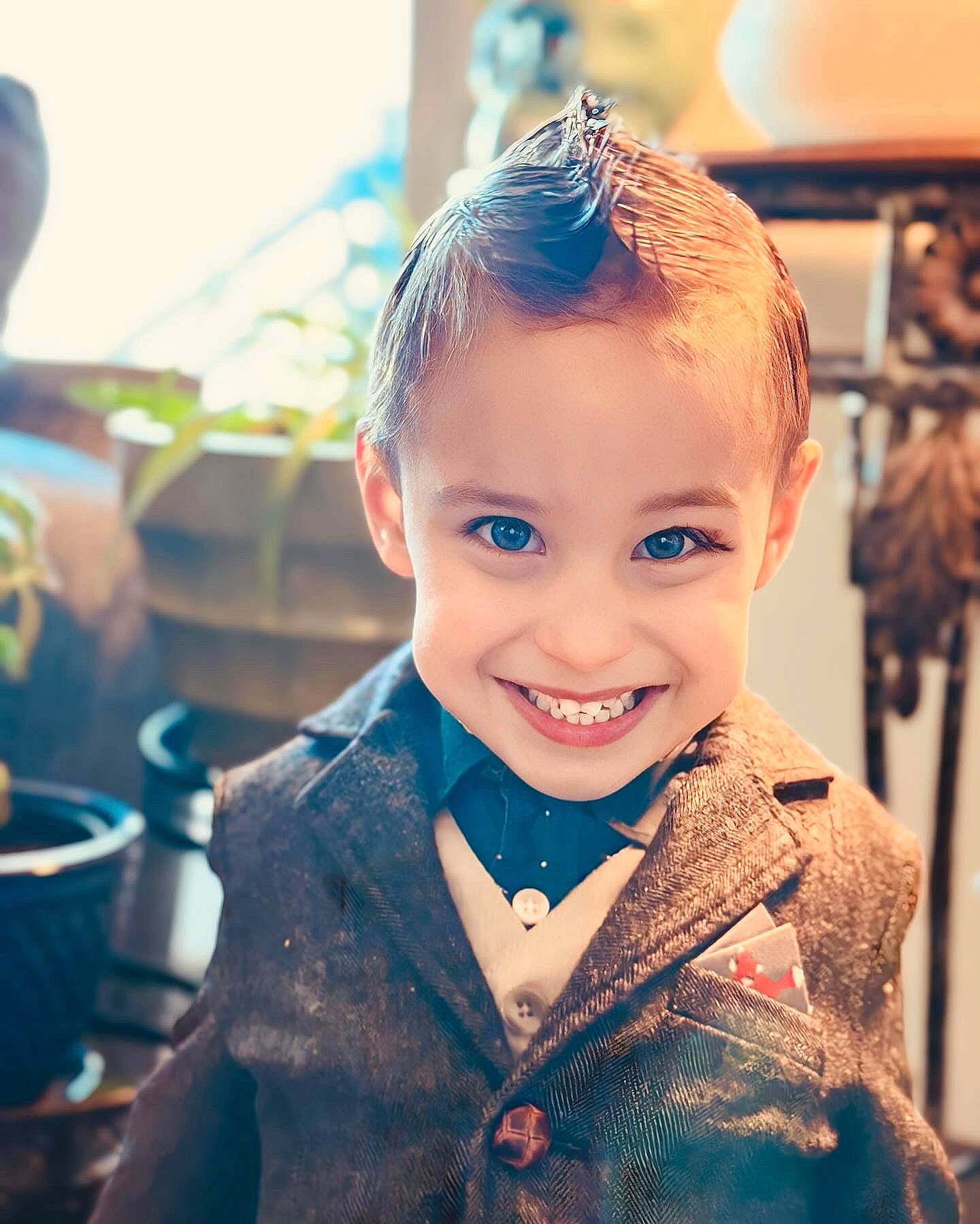 Kyler is registered to the contest to win money with this photo: bow_tie, child, collar, electric_blue, fashion_accessory, fashion_design, formal_wear, fun, happy, iris, joy, laugh, people, person, portrait_photography, sitting, sleeve, smile, suit, toddler