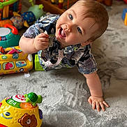 Declan joined the competition — help win amazing prizes! baby, child, toy, colorful, crawling, indoor, carpet, happy, play, hand, face, cute, smiling, infant, early_childhood, floor, expression, clothing, object, development